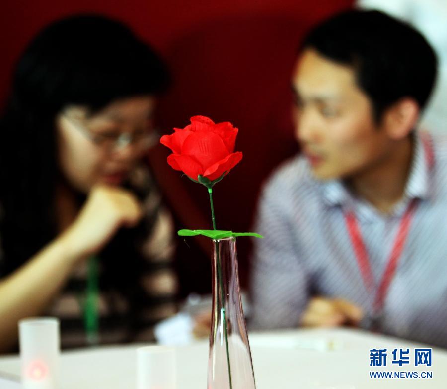 A man and a woman are in conversation in a blind date organized by Shanghai Second Marriage Fair on May 26, 2012. 