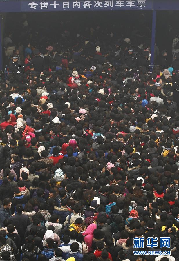 Thousands of travelers queue up for tickets at the train station ticket hall in Xi'an on Jan. 1, 2012. 