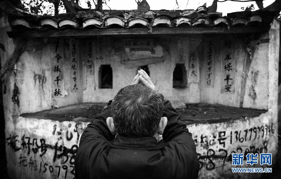 Zhang prays in the "water temple" and hopes to get harvest in the next year on Jan. 20, 2012. 