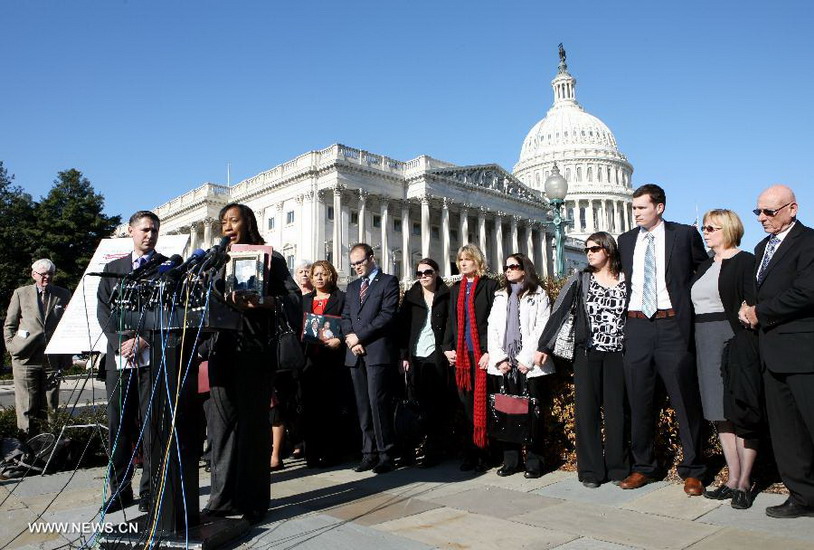 Family members who have lost their beloved ones and survivors of mass shootings gather in front of the Capitol Hill in Washington D.C. on Dec. 18, 2012. Families of victims share with the media a letter signed by families who have lost beloved ones in all of the recent mass shootings across the country. The letter will be delivered to the White House and Members of Congress. (Xinhua/Fang Zhe)