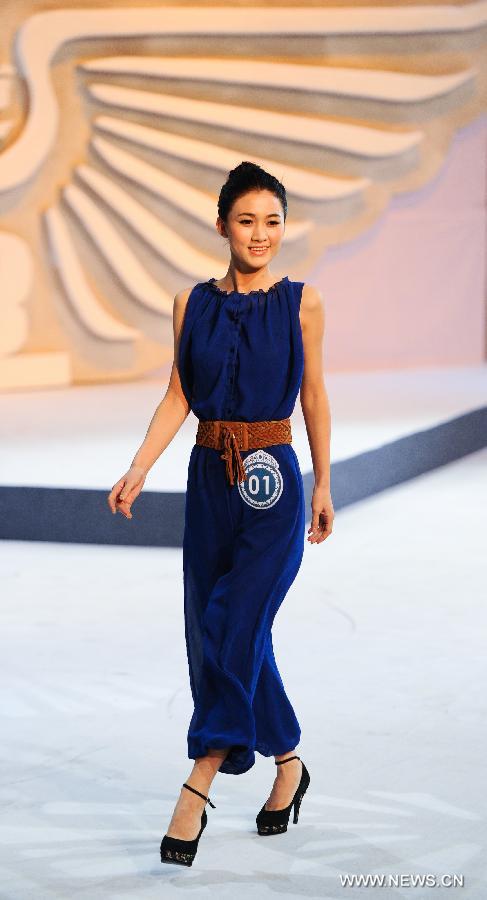 A contestant is pictured on the stage during a beauty contest in Changchun City, capital of northeast China's Jilin Province, Dec. 19, 2012. (Xinhua/Xu Chang)  