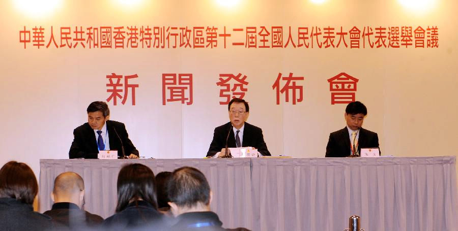 The presidium news spokesman Ambrose LAU Hon-chuen (C) speaks during the press conference after the third plenary session of the Conference for Electing Deputies of HKSAR to the 12th National People's Congress (NPC) in south China's Hong Kong, Dec. 19, 2012. The third plenary session of the Conference for Electing Deputies of HKSAR to the 12th NPC was held on Wednesday. (Xinhua/Wong Pun Keung)