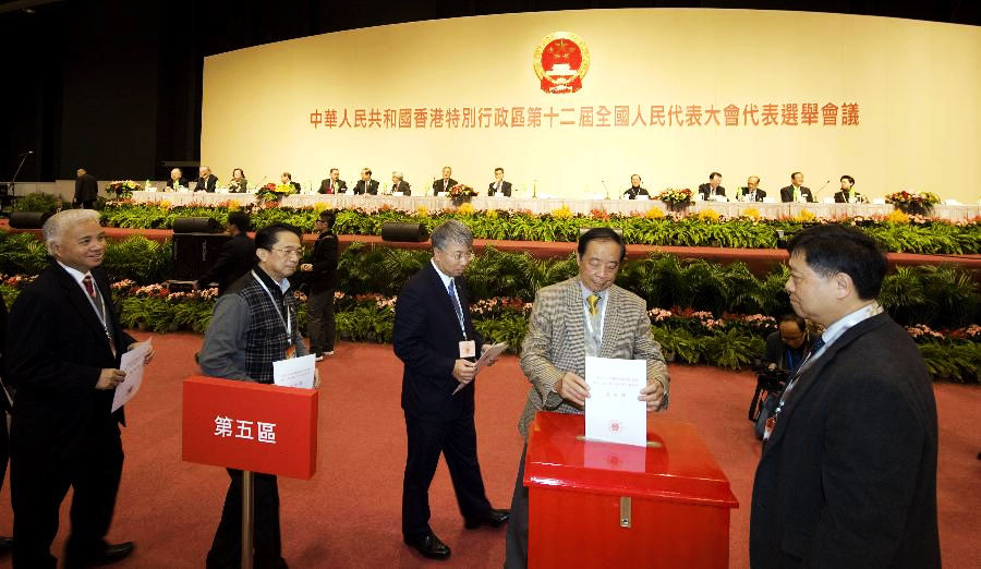 Members of the presidium vote at the Conference for Electing Deputies of the Hong Kong Special Administrative Region (HKSAR) to the 12th National People's Congress (NPC) in Hong Kong, south China, Dec. 19, 2012. (Xinhua/Lui Siu Wai)