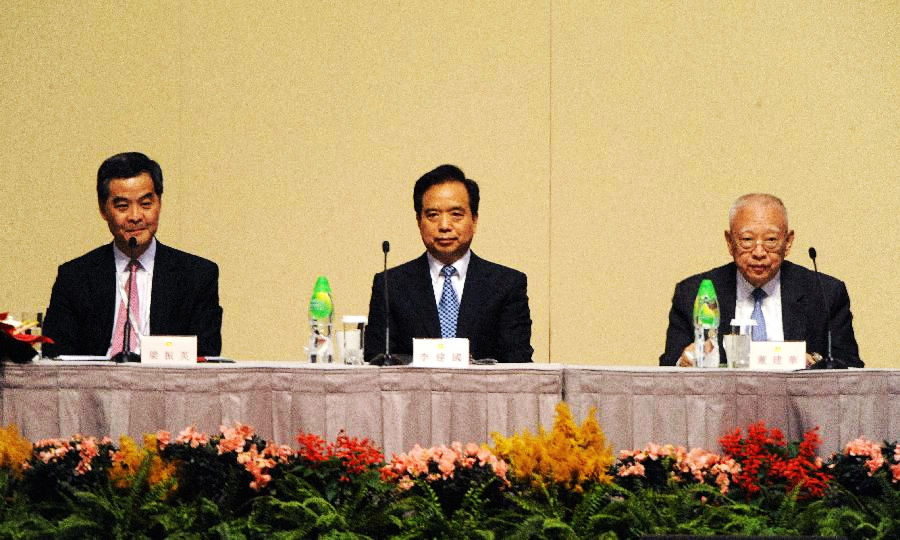 Vice Chairman and Secretary-General of the NPC Standing Committee Li Jianguo (C), chairman of the presidium CY Leung (L) and the member of the presidium Tung Chee-hwa attend the second plenary session of the Conference for Electing Deputies of the Hong Kong Special Administrative Region (HKSAR) to the 12th National People's Congress (NPC) in Hong Kong, Dec. 19, 2012.(Xinhua/Wong Pun Keung)