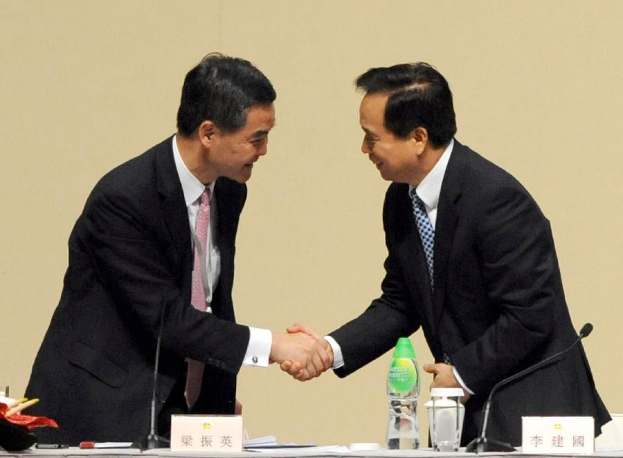Vice Chairman and Secretary-General of the NPC Standing Committee Li Jianguo (R) shakes hands with chairman of the presidium CY Leung at the second plenary session of the Conference for Electing Deputies of the Hong Kong Special Administrative Region (HKSAR) to the 12th National People's Congress (NPC) in Hong Kong, south China, Dec. 19, 2012. (Xinhua/Wong Pun Keung)