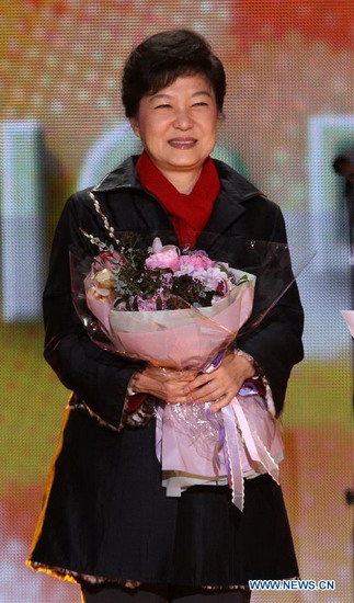 Park Geun-hye of South Korea's ruling Saenuri Party smiles as she holds a bouquet in Seoul, on Dec. 19, 2012. Park Geun-hye of South Korea's ruling Saenuri Party is poised to win the tightly contested presidential election Wednesday and become the first female leader of the country, local media reported. (Xinhua/Park Jin-hee)