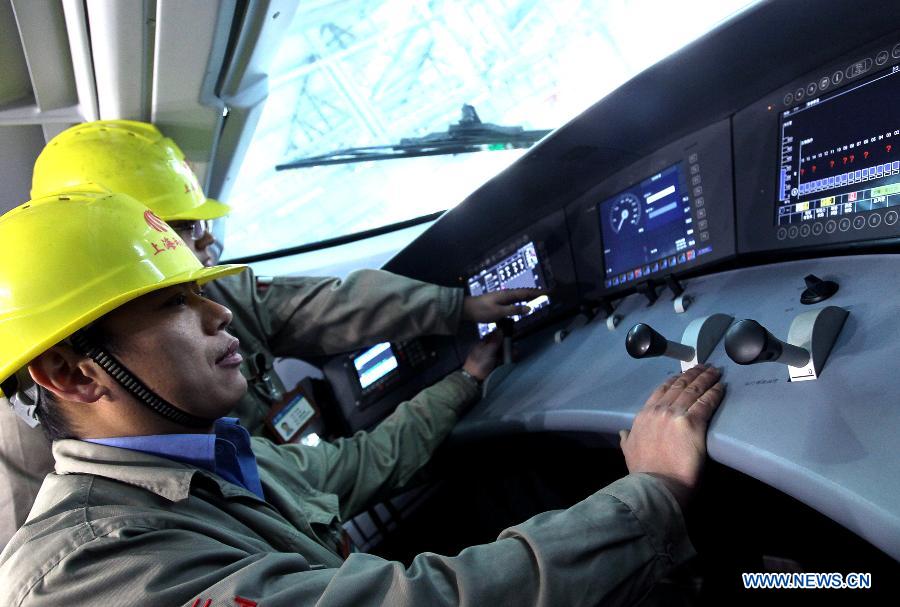 A technician checks the braking system of a bullet train in Shanghai Municipality, Dec. 19, 2012. Shanghai Railway Bureau conducted a comprehensive overhaul of all the bullet trains to ensure the demand of vehicles during the coming spring rush on Wednesday. (Xinhua/Chen Fei) 
