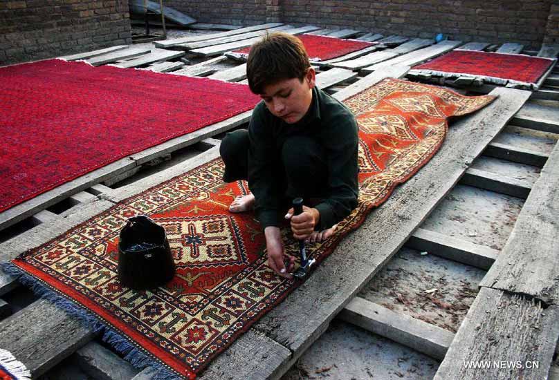 Pakistani boy crafts a hand-made carpet at a local carpet factory in northwest Pakistan's Peshawar, Dec. 20, 2012. According to reports, Pakistan's carpet exports have witnessed a huge decline of more than 50 percent during the last five years. (Xinhua/Ahmad Sidique)