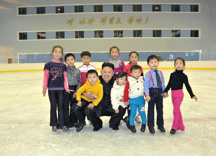 Photo released by Korean Central News Agency (KCNA) on Nov. 5, 2012 shows Kim Jong Un (C), top leader of the Democratic People's Republic of Korea (DPRK), posing with children as he visits the skating rink in Pyongyang on Nov. 3. (Xinhua/KCNA) 