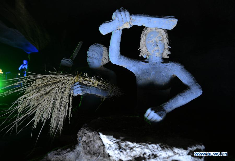 Photo shows the sculptures imitating ancient people's life at the Xianren Cave in Dayuan Township of Wannian County, east China's Jiangxi Province. Xianren Cave is the location for historically important finds of prehistoric pottery sherds and rice remains. (Xinhua/Zhou Ke)