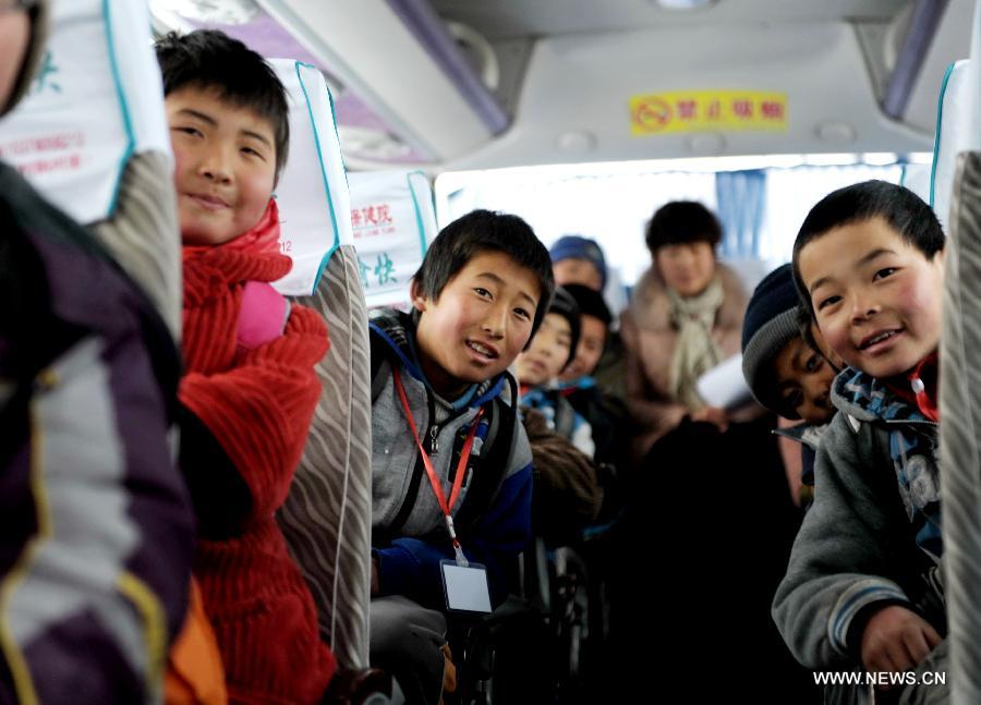 Students pose for pictures on a school bus in Gaolan county, Lanzhou city of northwest China's Gansu province, Dec. 21, 2012. According to local educational authorities, a total of 3,117 lines of school buses were put to use, providing service for more than 300,000 boarders of compulsory students. (Xinhua/Nie Jianjiang) 