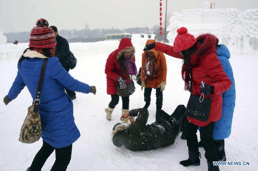 Tourists play on the snow ground at the 25th Harbin Sun Island International Snow Sculpture Art Expo. in Harbin, capital of northeast China's Heilongjiang Province, Dec. 21, 2012. The expo kicked off on Friday. (Xinhua/Wang Feng) 