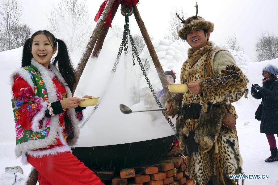 Working staff dressed in traditional clothes cook for tourists during the 25th Harbin Sun Island International Snow Sculpture Art Expo. in Harbin, capital of northeast China's Heilongjiang Province, Dec. 21, 2012. The expo kicked off on Friday. (Xinhua/Wang Feng) 