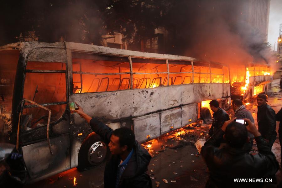 Buses are seen ablaze during clashes between Islamists and their opponents in Egypt's northern seaside city of Alexandria on Dec. 21, 2012. The clashes came one day ahead of the second round of the country's constitutional referendum. (Xinhua/Wissam Nassar) 