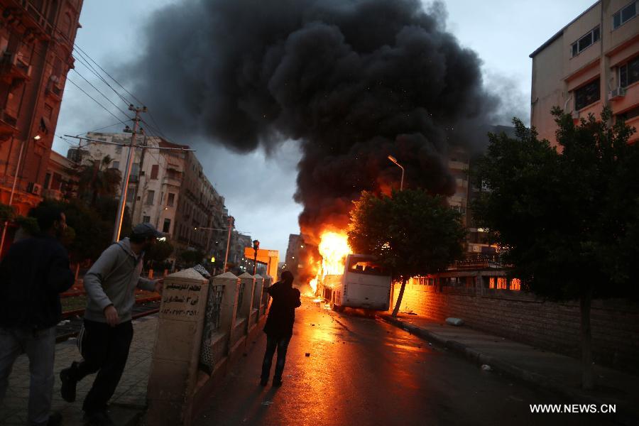 Buses are seen ablaze during clashes between Islamists and their opponents in Egypt's northern seaside city of Alexandria on Dec. 21, 2012. The clashes came one day ahead of the second round of the country's constitutional referendum. (Xinhua/Wissam Nassar)