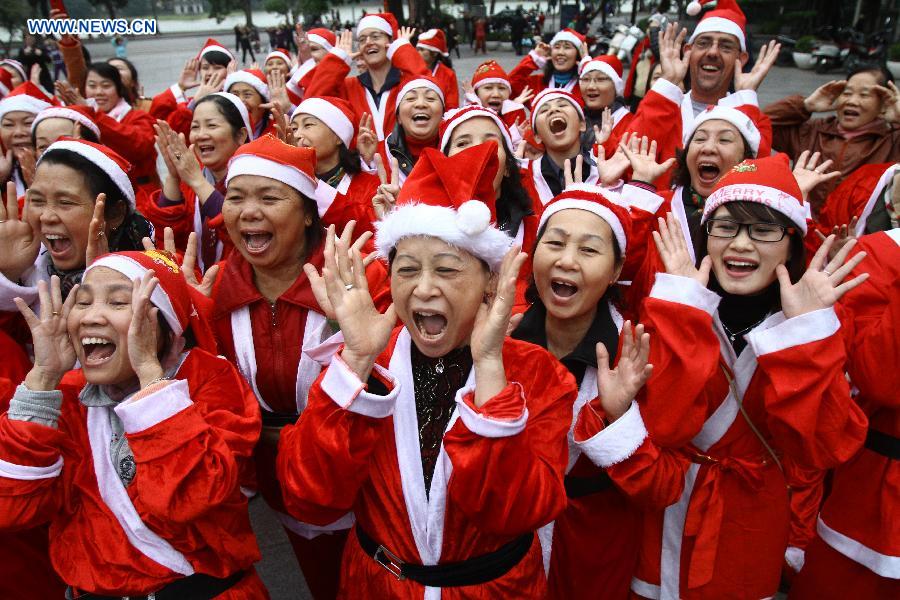 Members of the "Laughter Yoga" club participate in an event called "Christmas Smile" near the Hoan Kiem Lake in Hanoi, Vietnam, on Dec. 23, 2012. (Xinhua/Ho Nhu Y) 