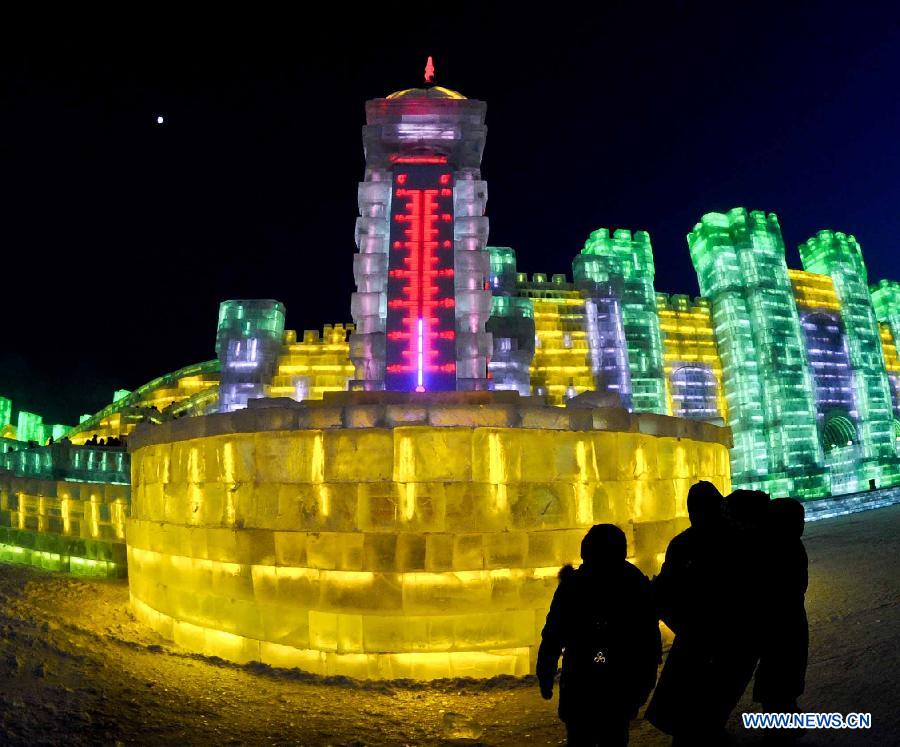 Tourists look at a thermometer-shaped snow sculpture at the 29th Harbin International Ice and Snow Festival in Harbin, capital of northeast China's Heilongjiang Province, Dec. 23, 2012. The festival kicked off at the Harbin Ice and Snow World on Sunday. (Xinhua/Wang Song)