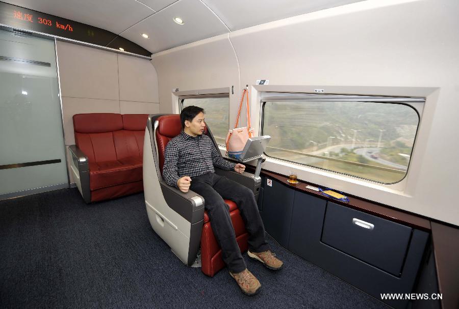 A passenger looks at the scenery out of the window in a tourist carriage of G80 express train during a trip to Beijing, capital of China, Dec. 22, 2012.