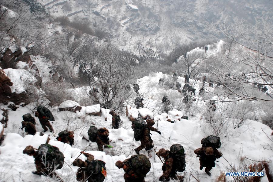 Soldiers march a mountain snow during a military training in central China's Henan Province, Dec. 19, 2012. Thousands of soldiers went through harsh environment as they participated in the military training here. (Xinhua/Shen Dongdong) 