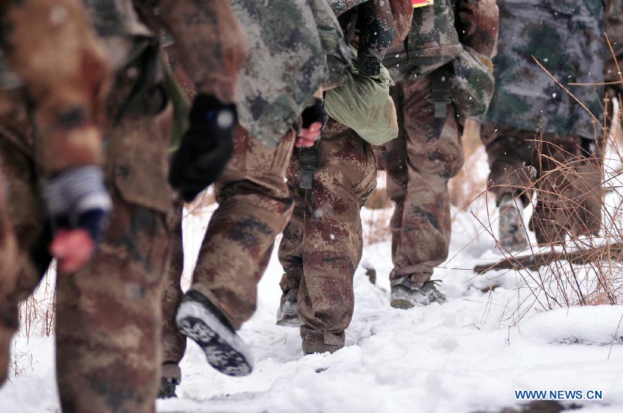 Soldiers march on a snowy road during a military training in central China's Henan Province, Dec. 19, 2012. Thousands of soldiers from Jinan Military Region in east China went through harsh environment as they participated in the military training here. (Xinhua/Shen Dongdong) 