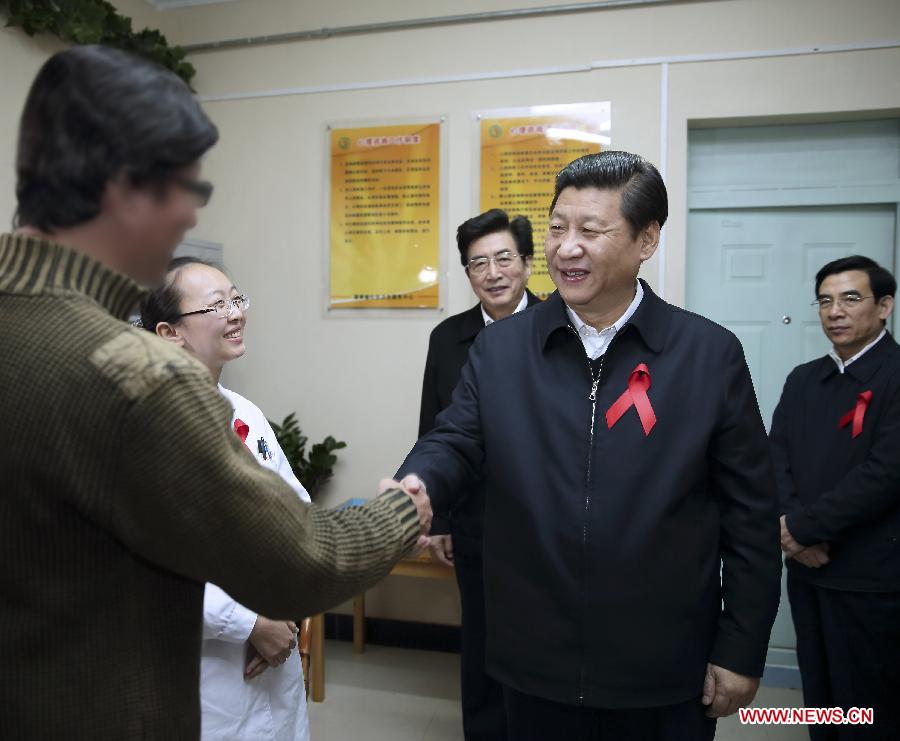 File photo taken in November 2012 shows Xi Jinping shakes hands with an HIV carrier as he participates in activities of the World Aids Day at Health Service Center of Puhuangyu Community in Fengtai District of Beijing, capital of China. (Xinhua/Lan Hongguang) 