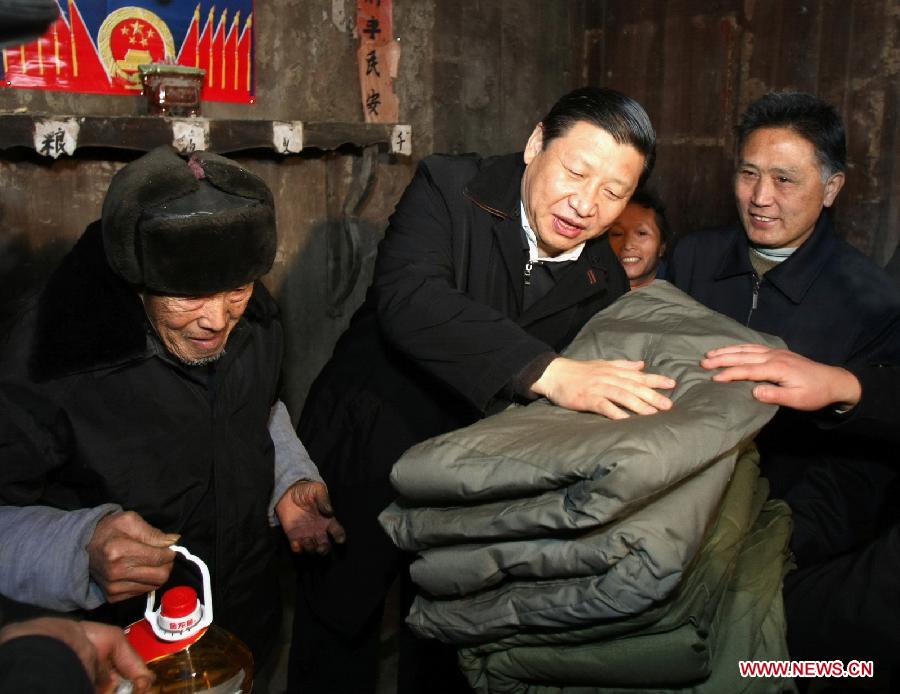 File photo taken in January 2008 shows Xi Jinping (C) visits Tang Zhaowei, a villager of Dong ethnic group who suffered a loss in the snow and ice storms, in Laoshankou Village of Gaolouping Township, southwest China's Guizhou Province. (Xinhua/Lan Hongguang) 