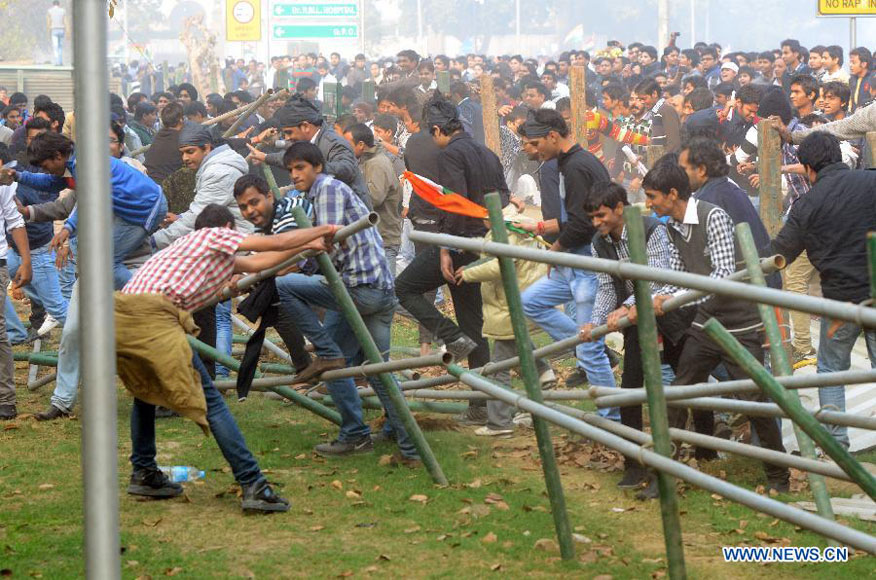 Protestors destroy barricade during a demonstration at the India Gate in New Delhi, India, on Dec. 23, 2012. Indian students Sunday continued their week-long protest against a horrifying gangrape of a young woman last Sunday and asked Congress President Sonia Ganghi to immediately intervene. (Xinhua/Partha Sarkar) 
