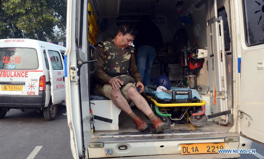 An injured policeman sits in an ambulance during a protest at the India Gate in New Delhi, India, on Dec. 23, 2012. Indian students Sunday continued their week-long protest against a horrifying gangrape of a young woman last Sunday and asked Congress President Sonia Ganghi to immediately intervene. (Xinhua/Partha Sarkar) 