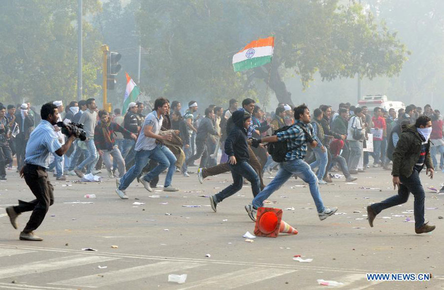 Protestors hurl stones during a demonstration at the India Gate in New Delhi, India, on Dec. 23, 2012. Indian students Sunday continued their week-long protest against a horrifying gangrape of a young woman last Sunday and asked Congress President Sonia Ganghi to immediately intervene. (Xinhua/Partha Sarkar) 