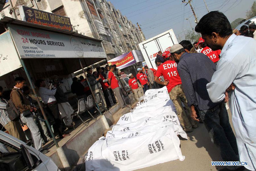 Pakistani rescuers arrange dead bodies of illegal immigrants for identification, who were killed near the border with Iran, in southern Pakistani port city Karachi, on Dec. 23, 2012. Some unknown gunmen killed at least 10 people on Friday evening as they attacked a passenger vehicle in Pakistan's southwestern province of Baluchistan, local media reported. (Xinhua/Arshad)