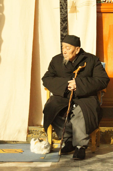 Wang Shoutian, head of the Lingming Temple in Lanzhou, Gansu Province, sits in the sunshine with his cat on December 7, 2012. Originally built at the end of Qing Dynasty, the temple occupies about 9,100 square meters and features both traditional Chinese and Islamic elements. (CRIENGLISH.com/Guo Jing)