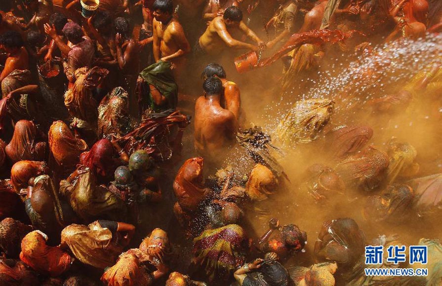 Men drench women with liquid colors and women tear off the clothes of the men during "Huranga", the festival of colors in Mathura, India on March 9, 2012 (Xinhua/AFP Photo)
