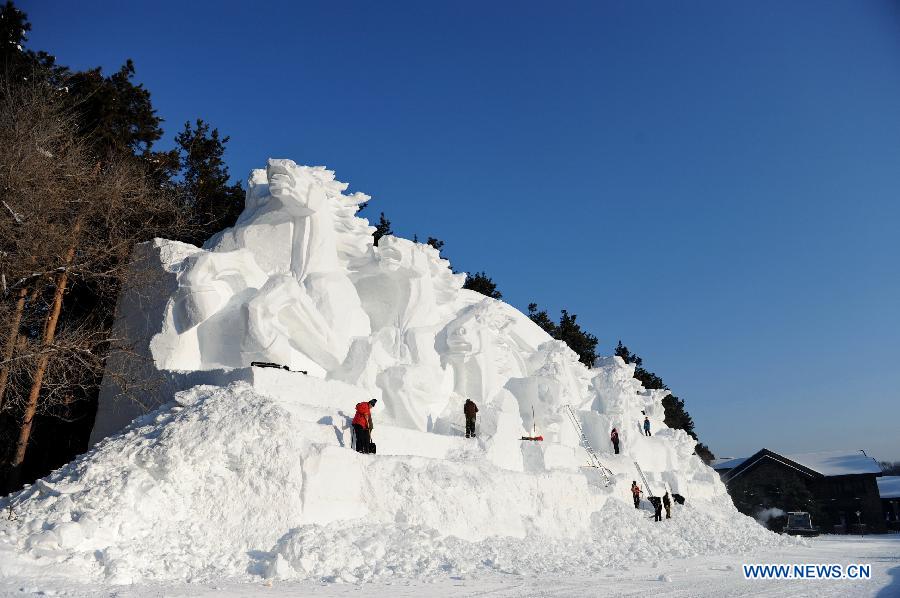 Workers shape a snow sculpture at Jingyuetan National Forest Park in Changchun, capital of northeast China's Jilin Province, Dec. 24, 2012. The "Jingyue Snow World", with numbers of snow sculptures, opened to tourists on Monday.(Xinhua/Zhang Nan)