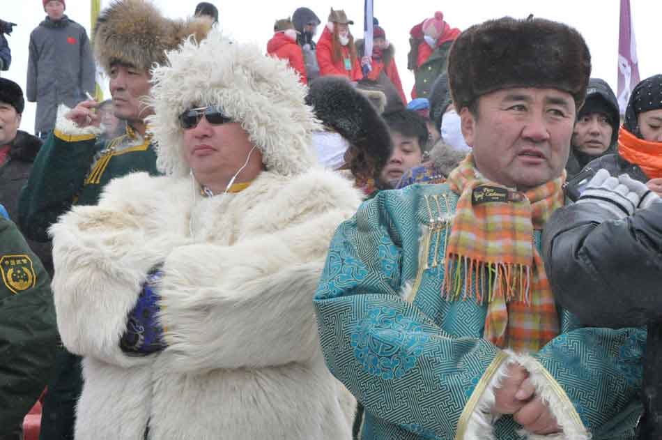 Photo taken on Dec. 24 shows audience wearing national costumes at the opening ceremony of 2012 Inner Mongolia Winter Ice and Snow Nadam Fair as well as the Fire Sacrifice Festival of Chenbaerhu Grassland in Hulun Buir, north China's Inner Mongolia Autonomous Region. (People's Daily Online/Zeng Shurou)