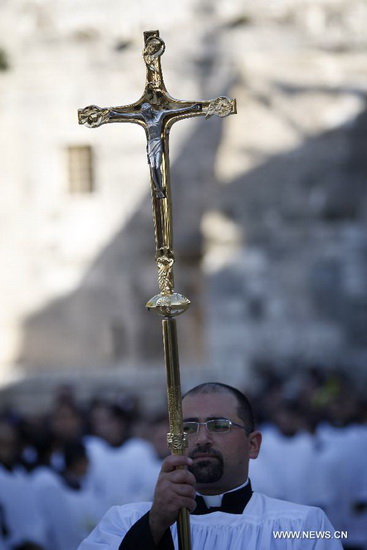 Clergymen take part in the Christmas celebrations outside the Church of the Nativity in West Bank town of Bethlehem on Dec. 24, 2012. (Xinhua/Fadi Arouri)