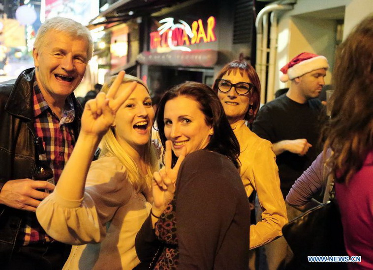 Foreign visitors celebrate the Christmas at Lan Kwai Fong, a commercial area in Hong Kong, south China, early Dec. 25, 2012. (Xinhua/Li Peng) 