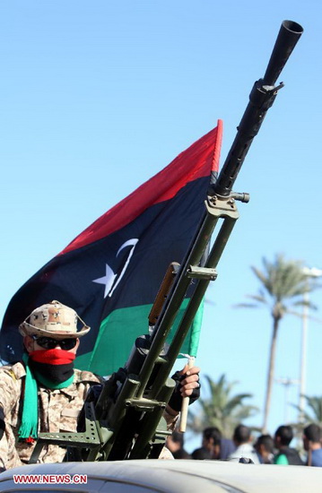 A libyan soldier attends a military parade to mark the 61st anniversary of Independence Day at Martyrs' Square in Tripoli, Libya, Dec. 24, 2012. (Xinhua/Hamza Turkia)