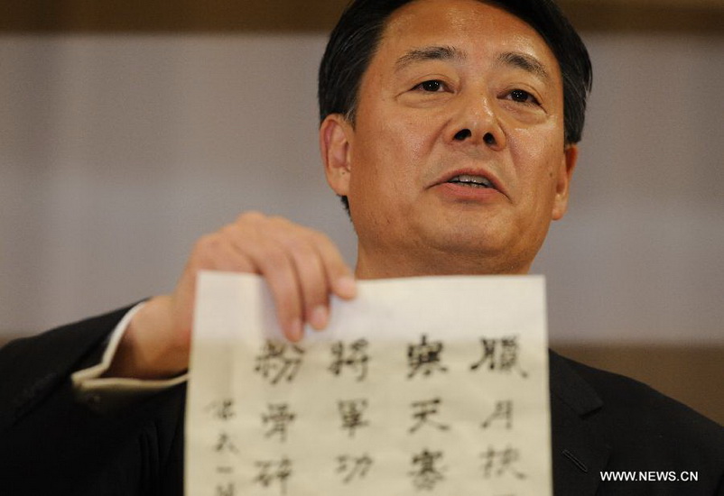 Banri Kaieda, new leader of the Democratic Party of Japan (DPJ) and former trade minister, shows his poem written with Chinese characters after the the leadership election of DPJ in Tokyo, Dec. 25, 2012. Banri Kaieda on Tuesday became the new leader of the DPJ. (Xinhua/Kenichiro Seki)  