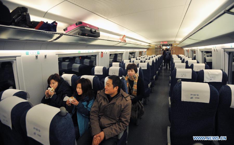 Passengers sit in high-speed train G502 at the Changsha South Railway Station in Changsha, capital of central China's Hunan Province, Dec. 26, 2012. The Changsha South Railway Station is one of the stops of the 2,298-kilometer Beijing-Guangzhou High-speed Railway, the world's longest, which was put into operation on Wednesday(Xinhu/Li Ga) 