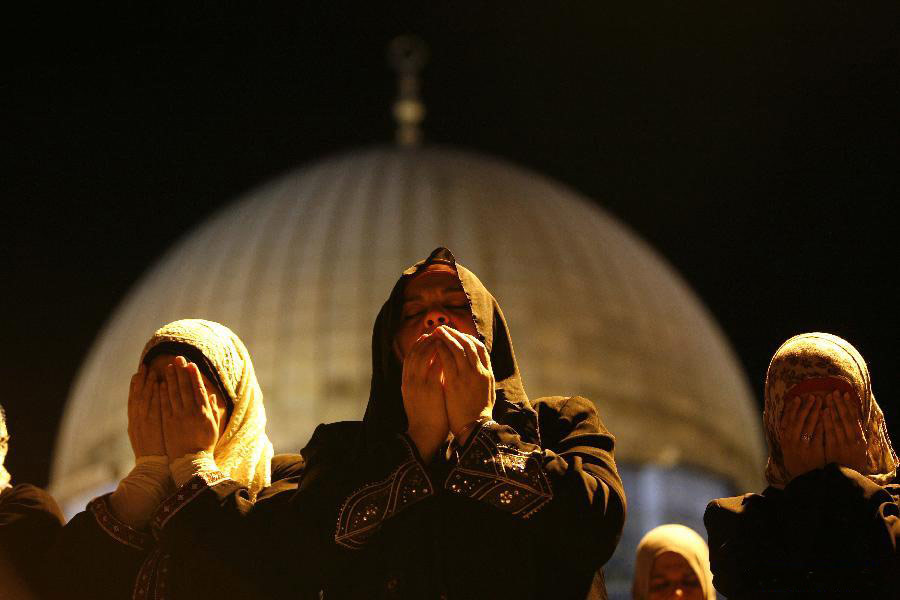 Jerusalem's Old City, Israel, on August 14, 2012. Laylat Al-Qadr is the holiest night in Ramadan month which commemorates the revealing of the holy book of Quran to Prophet Mohammad. (Xinhua/Muammar Awad) 