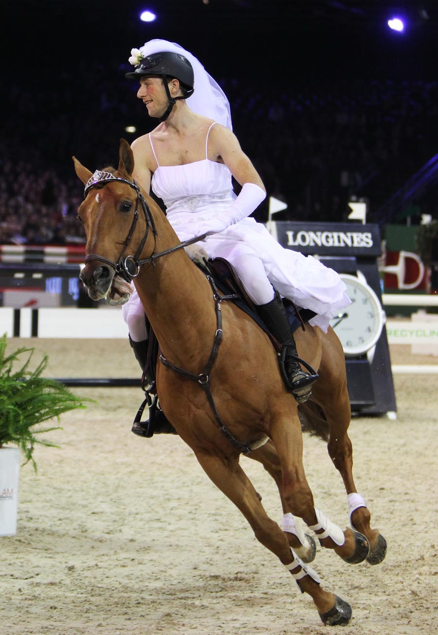 A rider dresses up as a “bride” to compete in the Gucci Paris Masters 2012 at Villepinte International Exhibition Center in Paris, France, which was held from Nov. 30, 2012 to Dec. 2, 2012. (Xinhua/Gao Jing)