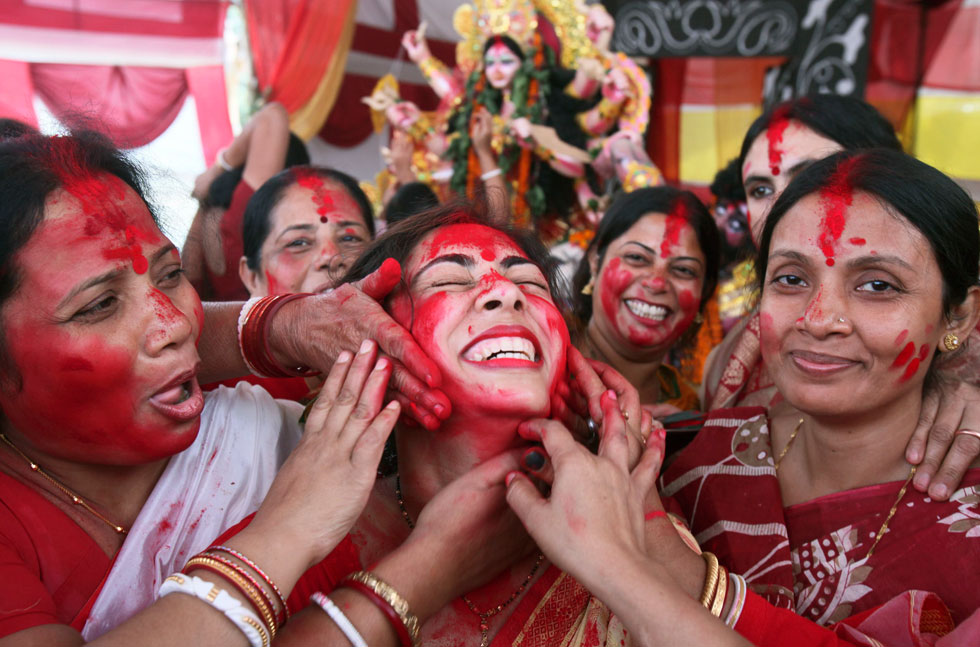 A lady's face is colored in red on the Durga Puja Festival held in Chandigarh, India, on Oct. 24, 2012. (Xinhua/AFP)   