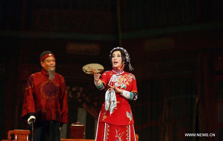 Actress Liu Xiaoqing (R) performs during a stage drama, which tells a story of famous courtesan Sai Jinhua, a legendary but controversial figure in the late Qing Dynasty (1644-1911), in Nanjing, capital of east China's Jiangsu Province, Dec. 25, 2012. (Xinhua) 