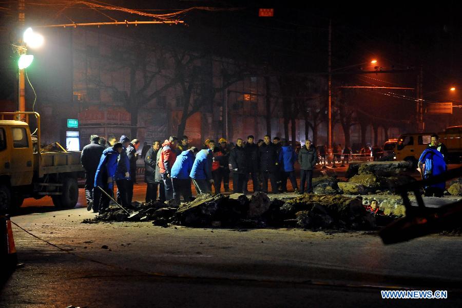 Workers fix the collapsed section of a road intersection in Taiyuan, capital of north China' Shanxi Province, Dec. 26, 2012. The road cave-in happened Wednesday afternnon, leaving a pit measuring around 3 to 4 meters deep, 15 meters long, and 5 meters wide. No casualties were reported. (Xinhua/Fan Minda)