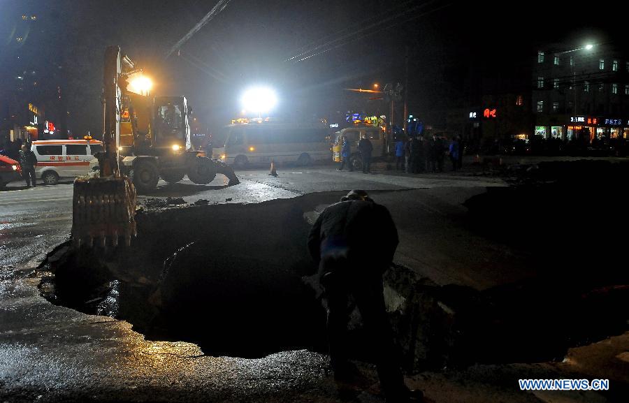 Workers fix the collapsed section of a road intersection in Taiyuan, capital of north China' Shanxi Province, Dec. 26, 2012. The road cave-in happened Wednesday afternnon, leaving a pit measuring around 3 to 4 meters deep, 15 meters long, and 5 meters wide. No casualties were reported. (Xinhua/Fan Minda)