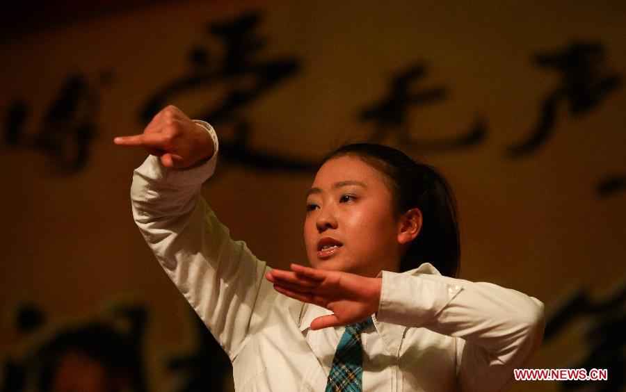 A contestant attends the fifth Hubei Inter-University Sign Language Friendship Competition in Wuhan, capital of central China's Hubei Province, Dec. 25, 2012. The competition, initiated in 2008, aims at promoting sign language knowledge and social awareness among students. (Xinhua/Cheng Min) 