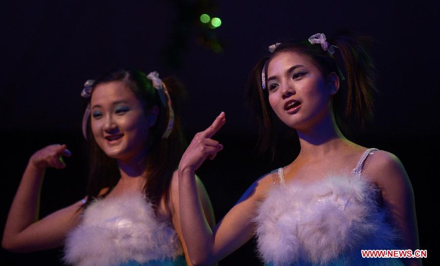 Contestants give performance during the fifth Hubei Inter-University Sign Language Friendship Competition in Wuhan, capital of central China's Hubei Province, Dec. 25, 2012. The competition, initiated in 2008, aims at promoting sign language knowledge and social awareness among students. (Xinhua/Cheng Min) 