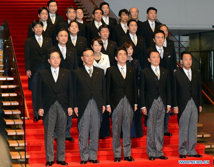 Shinzo Abe (Front C), leader of the ruling Liberal Democratic Party, poses for photos with members of a new cabinet in Tokyo, capital of Japan, on Nov. 26, 2012. Japan's new Chief Cabinet Secretary Yoshihide Suga on Wednesday announced members of a new cabinet led by Prime Minister Shinzo Abe, who just claimed the post in a special session of the Diet. (Xinhua/Ma Ping)