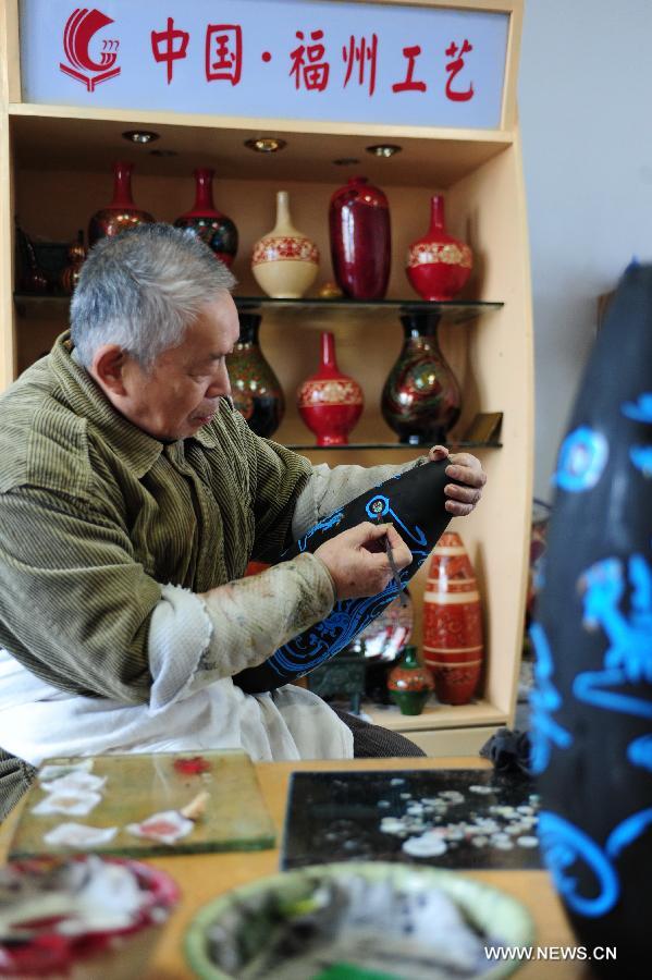 Craftsman Liu Zhangxin works on a bodiless lacquerware at a conservation base for bodiless lacquerware in Fuzhou, capital of southeast China's Fujian Province, Dec. 27, 2012. (Xinhua/Lin Shanchuan)