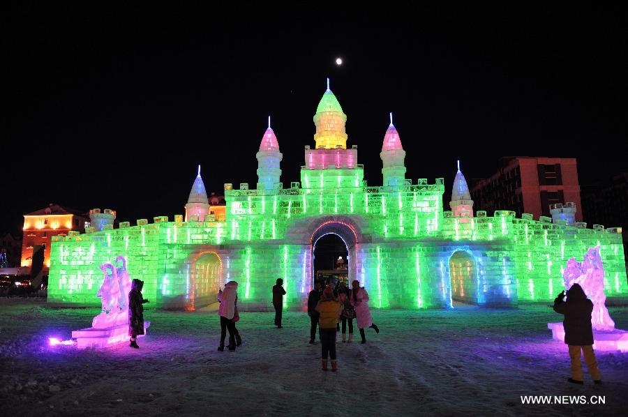 People view ice sculptures in border city Manzhouli in north China's Inner Mongolia Autonomous Region, Dec. 25, 2012. The 14th China, Russia and Mongolia Ice and Snow Sculpture Festival kicked off here on Tuesday. (Xinhua/Asigang) 